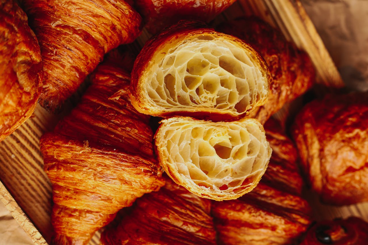 Delicious freshly baked croissants, golden and flaky, perfect for breakfast or brunch.